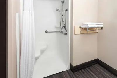 a bathroom with a shower with a shower curtain at Super 8 by Wyndham Mt. Vernon in Mount Vernon