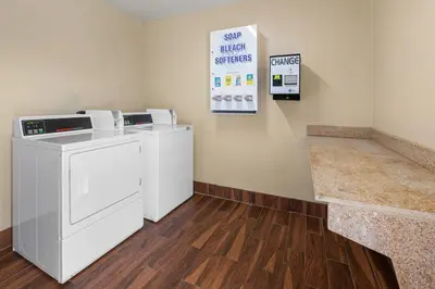 a laundry room with a washer and dryer at Days Inn by Wyndham Wauseon in Wauseon