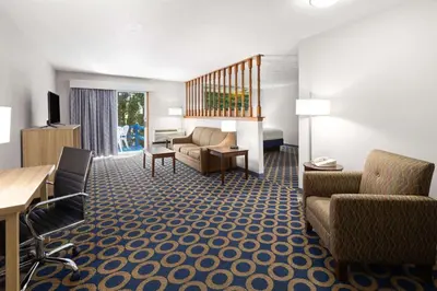 a living room with a couch and a desk at Days Inn by Wyndham Wauseon in Wauseon