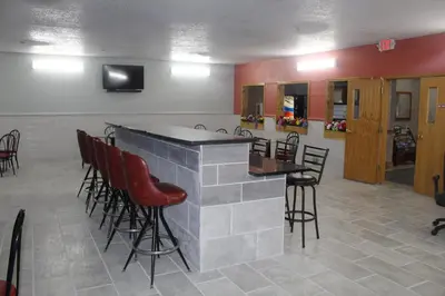 a bar in a room with chairs and a tv at Pier Inn in Luna Pier