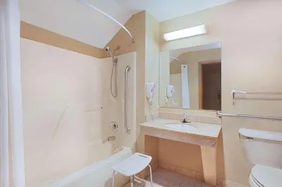 a bathroom with a sink and a tub and a toilet at Super 8 by Wyndham Defiance in Defiance