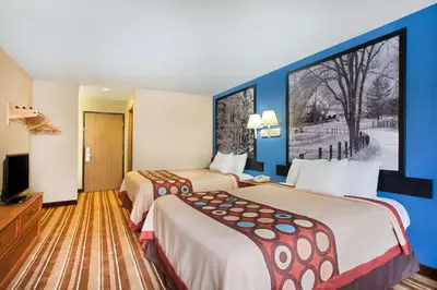 a hotel room with two beds and a large window at Super 8 by Wyndham Defiance in Defiance