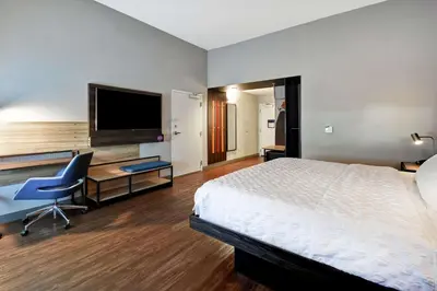 a hotel room with a bed and a desk and a tv at Tru By Hilton Cincinnati Airport South Florence in Florence