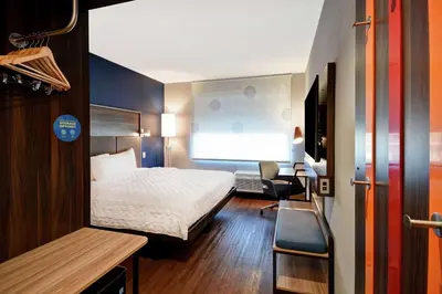 a hotel room with a bed and a desk and chair at Tru By Hilton Cincinnati Airport South Florence in Florence