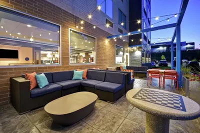 a patio with a couch and a table and chairs at Tru By Hilton Cincinnati Airport South Florence in Florence