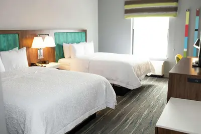 a hotel room with two beds and a window at Hampton Inn and Suites Dundee in Dundee