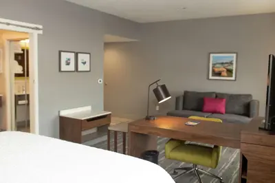 a room with a bed and a desk and a couch at Hampton Inn and Suites Dundee in Dundee