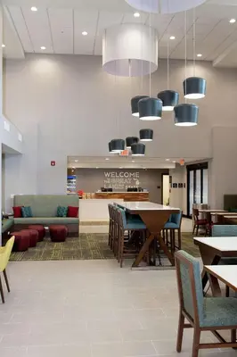 a lobby with tables and chairs and a waiting room at Hampton Inn and Suites Dundee in Dundee
