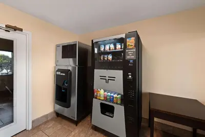 a refrigerator and a drink dispenser in a room at Best Western Executive Inn in Grove City