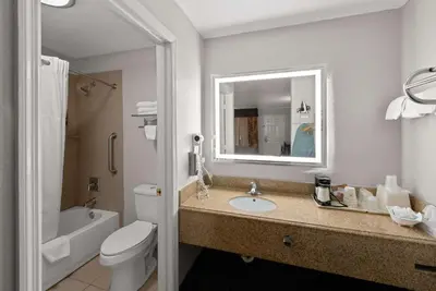 a bathroom with a sink and a toilet and a mirror at Best Western Executive Inn in Grove City