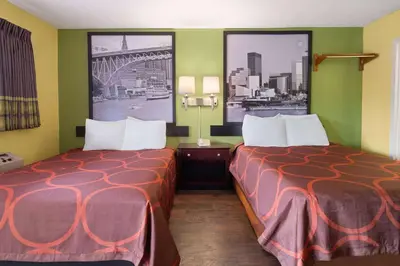 a hotel room with two beds and two windows at Super 8 by Wyndham Youngstown Girard in Youngstown