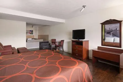 a hotel room with a bed and a flat screen tv at Super 8 by Wyndham Youngstown Girard in Youngstown