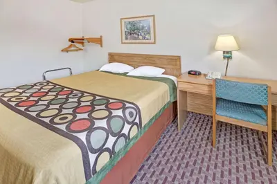 a hotel room with a bed and a desk and a chair at Super 8 by Wyndham Canonsburg/Pittsburgh Area in Canonsburg