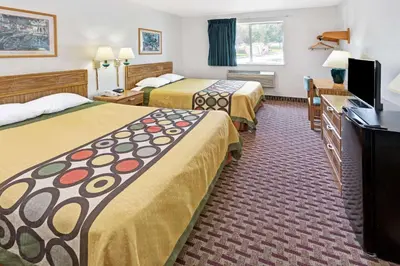 a hotel room with two beds and a flat screen tv at Super 8 by Wyndham Canonsburg/Pittsburgh Area in Canonsburg