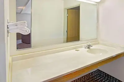 a bathroom with a sink and a mirror at Super 8 by Wyndham Canonsburg/Pittsburgh Area in Canonsburg