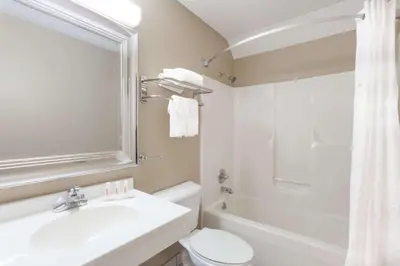 a bathroom with a sink and a toilet and a shower at Super 8 by Wyndham Adrian in Adrian