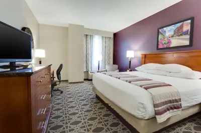 a hotel room with a bed and a flat screen tv at Drury Inn & Suites Middletown Franklin in Middletown