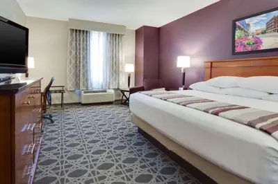 a hotel room with a large bed and a flat screen tv at Drury Inn & Suites Middletown Franklin in Middletown