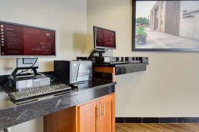 a office with a desk with a computer and a monitor at Drury Inn & Suites Middletown Franklin in Middletown
