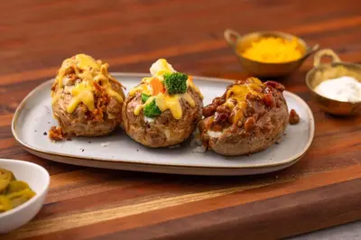 four muffins with cheese and broccoli on a plate at Drury Inn & Suites Middletown Franklin in Middletown