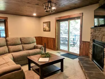 a living room with a couch and a fireplace at Sojourner's Lodge & Log Cabin Suites in Dundee