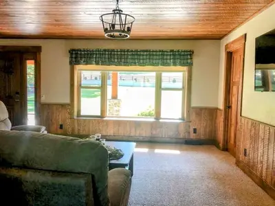 a living room with a couch and a window at Sojourner's Lodge & Log Cabin Suites in Dundee