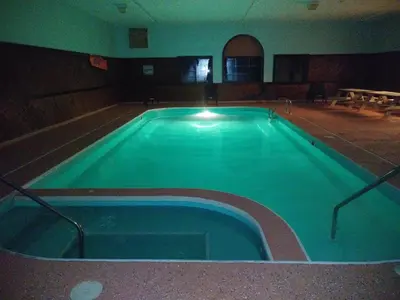 a large swimming pool in a large room at Super 8 by Wyndham Portsmouth in Portsmouth