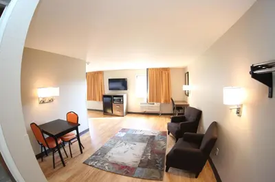 a living room with a couch and chairs and a table at Super 8 by Wyndham Portsmouth in Portsmouth
