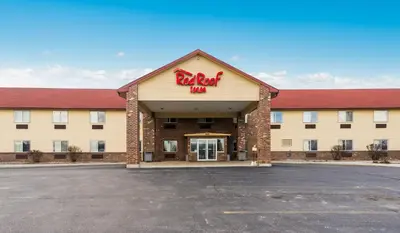a hotel with a sign on the front of it at Red Roof Inn Auburn in Auburn