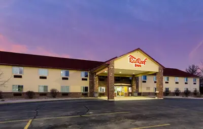 a hotel with a walmart sign in a parking lot at Red Roof Inn Auburn in Auburn