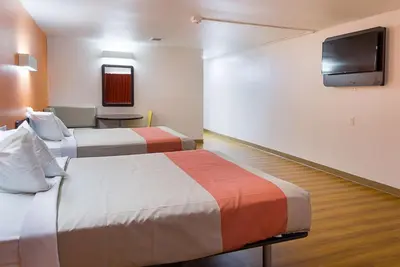 a hotel room with two beds and a flat screen tv at Motel 6-Sidney, OH in Sidney