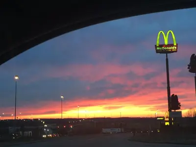 a mcdonalds sign in front of a sunset at Super 8 by Wyndham Seville in Seville