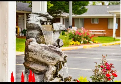 a stone fountain on the side of a street at Bryan Inn in Bryan