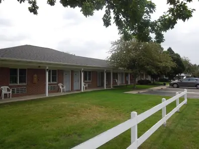 a house with a white fence in front of it at Bryan Inn in Bryan