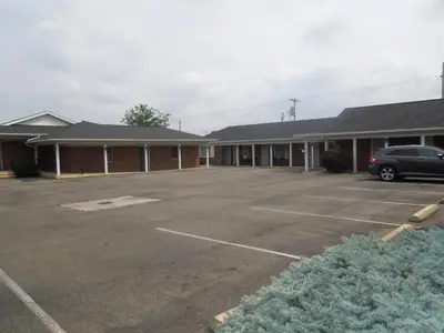 an empty parking lot in front of a building at Bryan Inn in Bryan