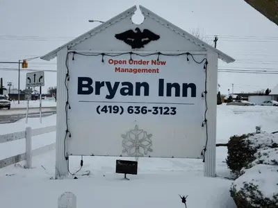 a sign for a bryan inn in the snow at Bryan Inn in Bryan