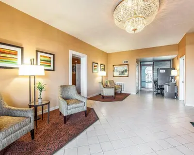 a lobby with couches and chairs and a chandelier at Quality Inn Maysville in Maysville