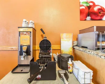 a kitchen counter with a coffee machine on a table at Quality Inn Maysville in Maysville