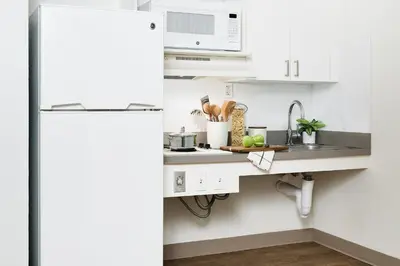 a kitchen with a sink and a white refrigerator at InTown Suites Extended Stay Cincinnati OH - Fairfield in Fairfield