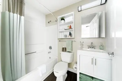 a white bathroom with a toilet and a sink at InTown Suites Extended Stay Cincinnati OH - Fairfield in Fairfield