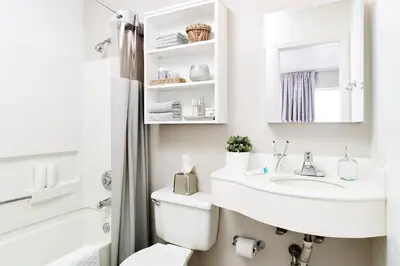 a white bathroom with a sink and a toilet at InTown Suites Extended Stay Cincinnati OH - Fairfield in Fairfield