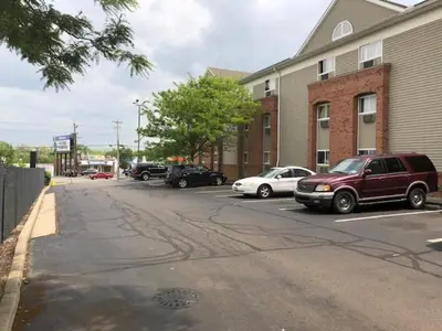 a street with cars parked in a parking lot at InTown Suites Extended Stay Cincinnati OH - Colerain in Cincinnati
