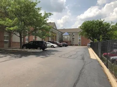a street with cars parked in front of a building at InTown Suites Extended Stay Cincinnati OH - Colerain in Cincinnati
