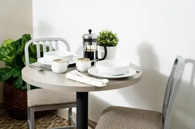 a table with plates and cups and a coffee maker on it at InTown Suites Extended Stay Columbus OH - Dublin in Columbus