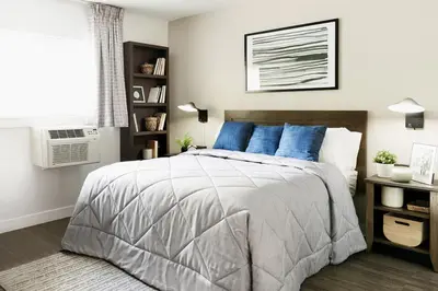 a bedroom with a large bed with blue pillows at InTown Suites Extended Stay Columbus OH - North in Columbus