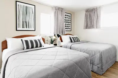 two beds in a bedroom with white walls at InTown Suites Extended Stay Columbus OH - North in Columbus