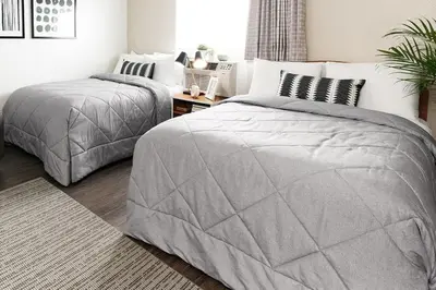 a bedroom with two twin beds and a table at InTown Suites Extended Stay Columbus OH - North in Columbus