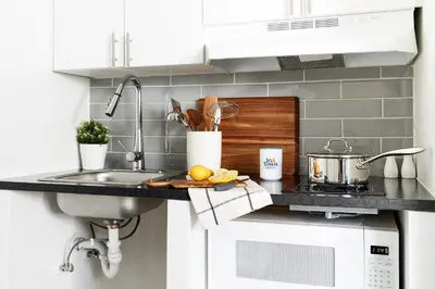 a kitchen counter with a sink and a stove at InTown Suites Extended Stay Select Dayton OH- Miamisburg in Dayton