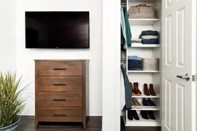 a closet with a television and a dresser with shoes at InTown Suites Extended Stay Select Dayton OH- Miamisburg in Dayton
