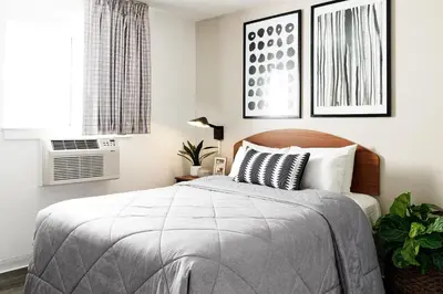 a bedroom with a bed and a window at InTown Suites Extended Stay Columbus OH - I-70E Hamilton Rd in Columbus